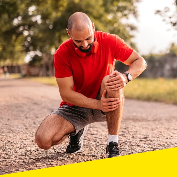 Man holds his knee due to discomfort or pain