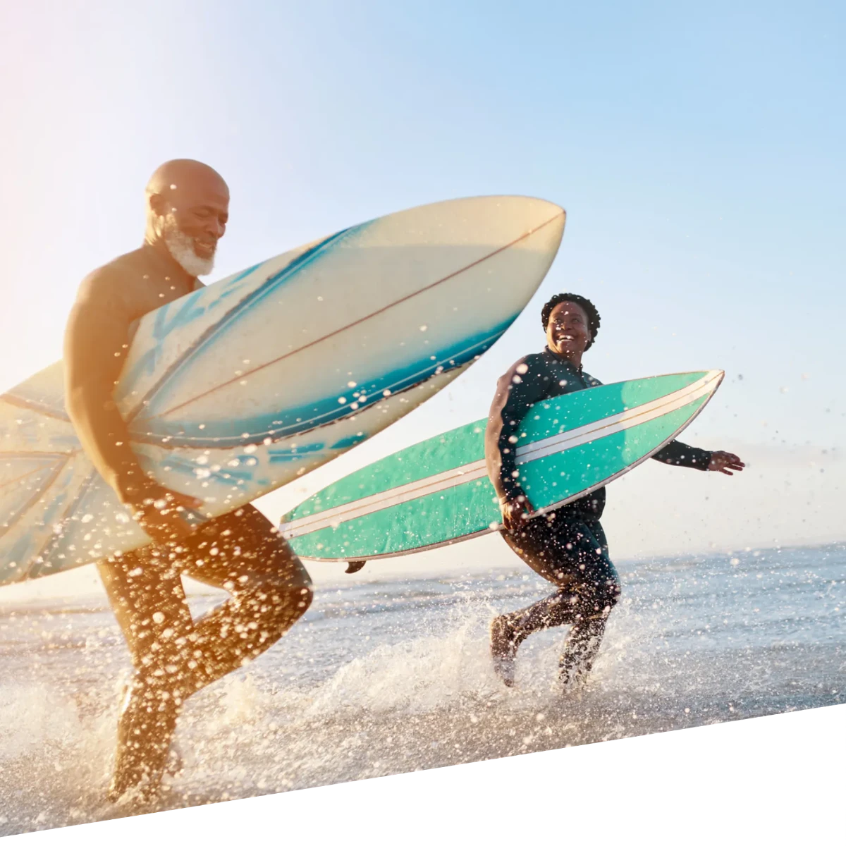 A group of people smiling after surfing together.