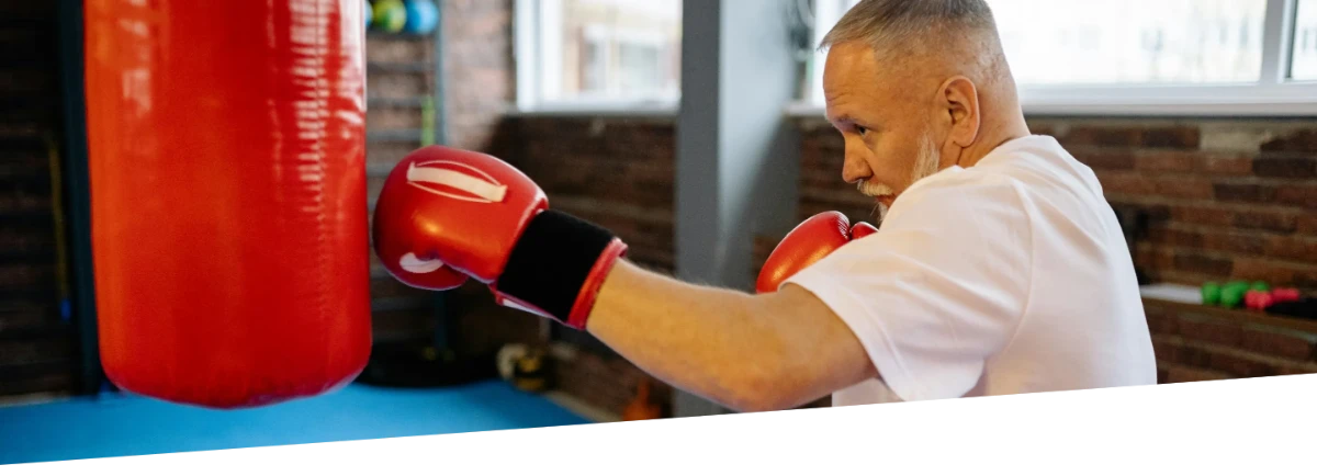 A man practicing boxing inside.