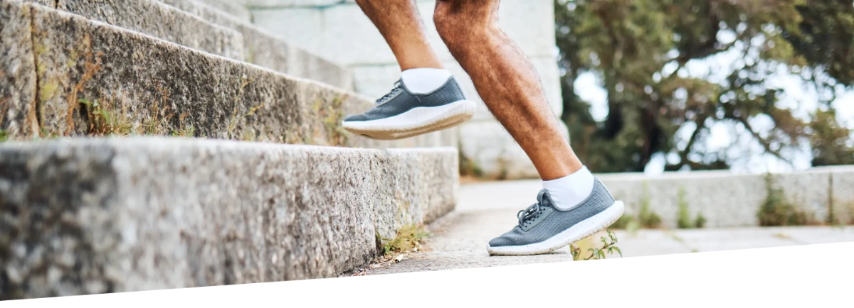 A person easily moving quickly up stone stairs.