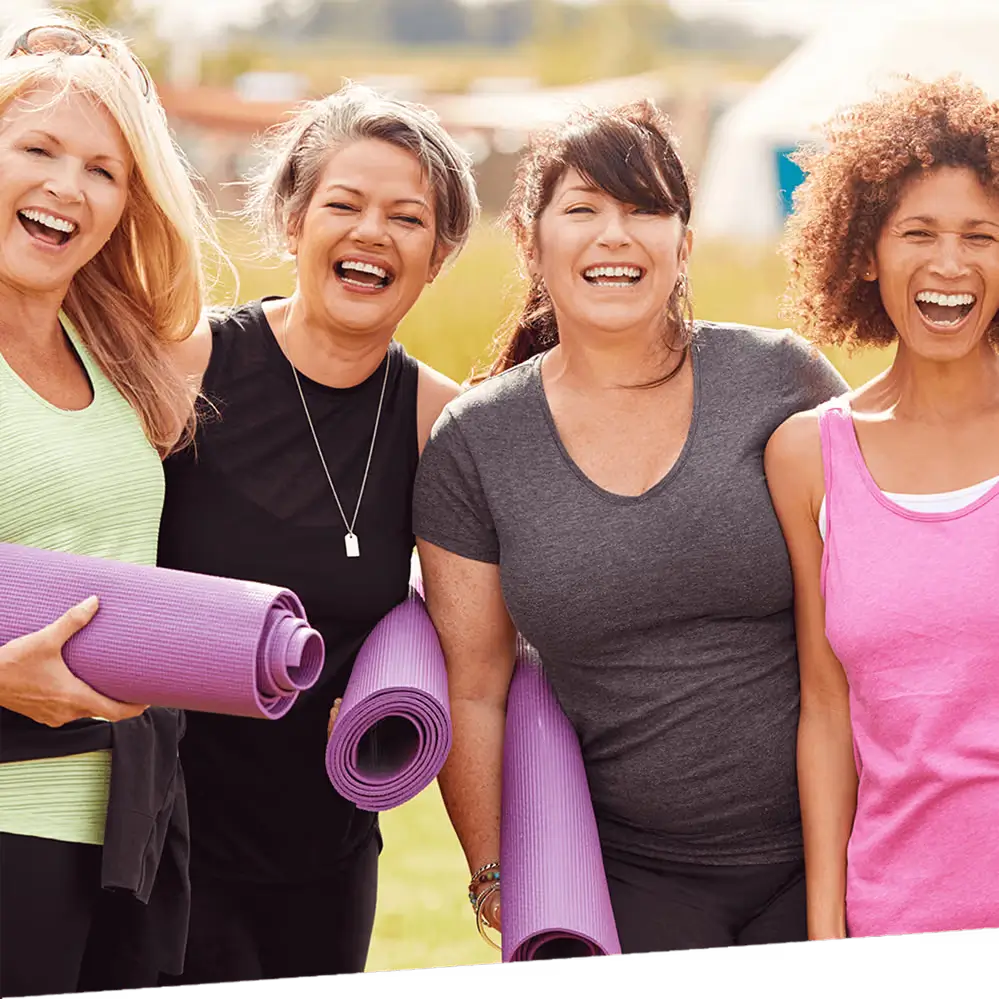 A group of woman smile after doing yoga.