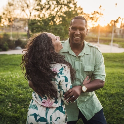 A couple happily embrace.